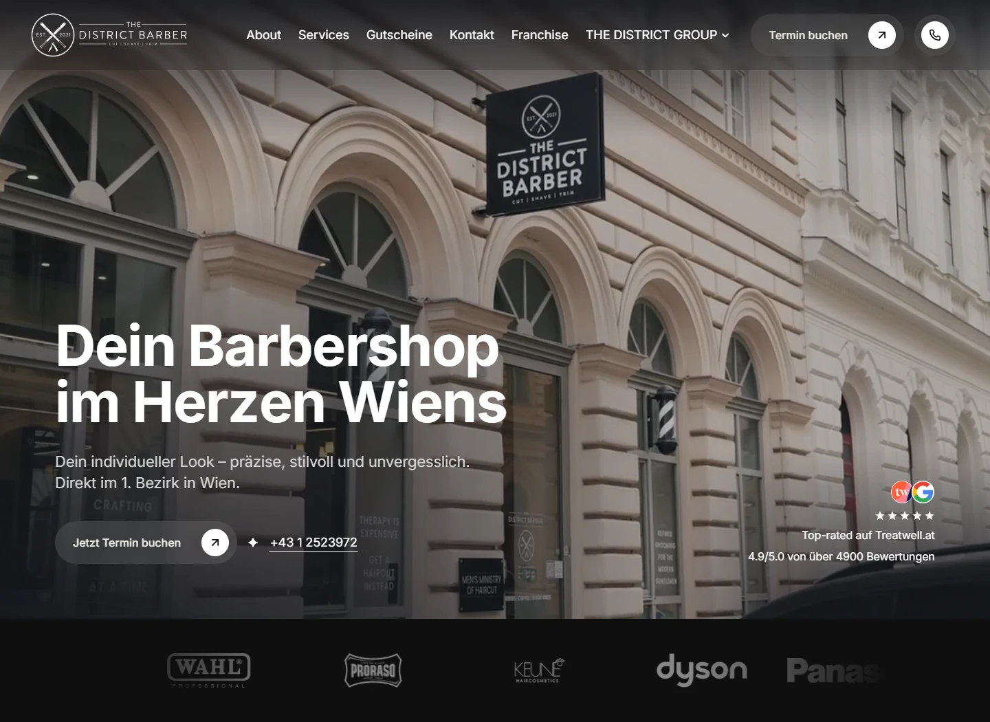 District Barber homepage with an elegant Vienna storefront and booking call to action
